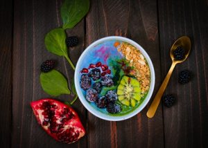 Smoothie fruit bowl filled with brightly coloured fruits as part of getting fit and healthy